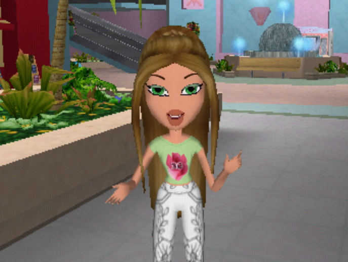 Fianna has long brown hair styled in a ponytail. Her skin is light. She wears a green top with a pink flower on the front and white jeans. Her eyes are green.
